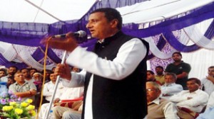 Minister for PHE, Irrigation and Flood Control Sham Lal Sharma addressing people in a function at Akhnoor on Tuesday.