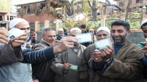 Workers of PDP burn their identity cards in protest of expulsion of MLA Rajpora, Syed Bashir from the party, at village Sheikhar in Pulwama district.