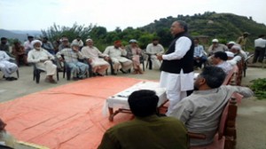 MLA Shabir Khan addressing villagers in Doongi-Garati area of Rajouri on Thursday. 