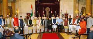 President Pranab Mukherjee, Vice President Hamid Ansari and Prime Minister Narendra Modi pose for a photograph with the newly sworn-in Ministers during swearing in ceremony at Rashtrapati Bhawan in New Delhi on Sunday. (UNI)