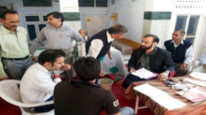 HoD Cardiology GMC Jammu Dr Sushil Sharma examining patients in a free medical camp at Bishnah on Sunday.