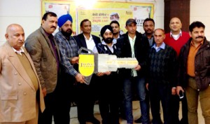 Officials of Jaypee Cement handing over key of Maruti car to winner of Scratch Card Coupon Scheme. -Excelsior/Rakesh