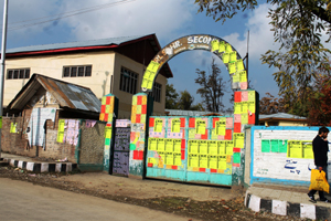 Main gate of Govt Girls Hr Sec School Shopian defaced with posters of coaching centres.