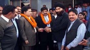 Registrar Cooperative Societies and Chairman CCB handing over keys of the Van and Scooty, during Cooperative Week celebration on Monday.