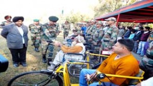 Army donating wheel chairs and tri-cycles to the physically challenged persons during camp at Pritam Park in Poonch. -Excelsior/Harbhajan