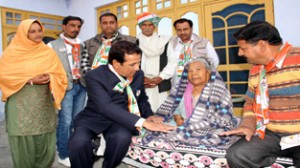 Former Minister RS Chib interacting with an old lady during door-to-door campaign.
