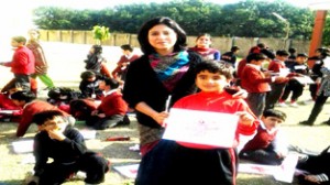 Student displaying painting during colour splash in Goenkan Acres.  