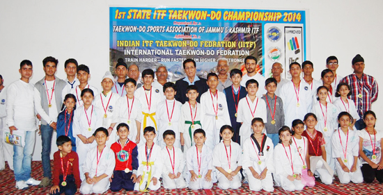 Taekwondo players posing for a group photograph along with former Sports Minister, R S Chib at Bari Brahmana in Samba.