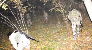 Cops conducting searches after attack on police bus in Awantipora on Tuesday. -Excelsior/Younis Khaliq