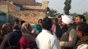 NC candidate Surinder Singh Bunty interacting with people during door to door campaign on Thursday.