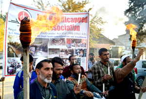 Members of Handicapped Association protesting at Srinagar on Friday. -Excelsior/Amin War