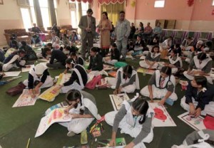 Students displaying their painting skills during a competition organized at Jammu.