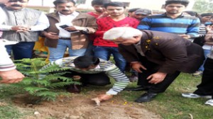 DDC Ajeet Kumar Sahu planting sapling in GCE premises on Monday.