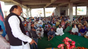 Former Minister Surjeet Singh Slathia addressing a public meeting on Tuesday.