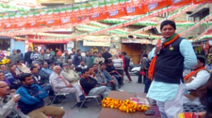 BJP candidate from Jammu East, Rajesh Gupta addressing poll meeting on Sunday. 