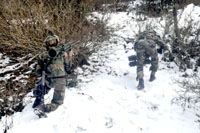Army jawans in action at the site of encounter in Nowgam sector of Kupwara district on Tuesday. -Excelsior/Aabid Nabi