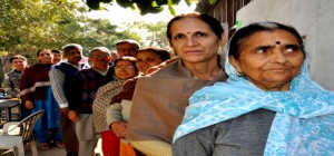 Kashmiri migrant voters in queue in front of a polling booth at Roop Nagar (Jammu) on Tuesday.— Excelsior / Rakesh