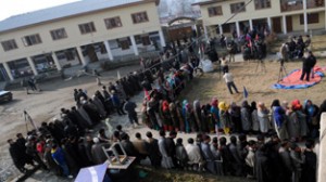 People stand in a long queue as they wait to cast their vote at a polling station in Handwara on Tuesday.  -Excelsior/Amin War