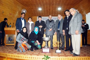 Members of Debating team of KU, who won Annual IIPA-DSW debate competition title posing along with trophy with dignitaries.