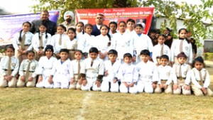 Winners of belt Grading Test posing  along with dignitaries at Wazir Janki Nath High School, Rani Bagh in Jammu.