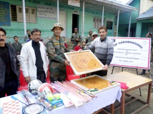 Army officer handing over sports items to a representative of GHS Mathola.