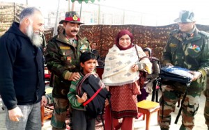 A poor child receiving clothes and essential items under Sadhbhavana on Thursday.