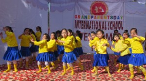 Children presenting colourful cultural item while celebrating Grandparents Day in Rajouri.