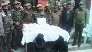 Police posing for photographs along with arrested smugglers and 54 packets of heroin seized in Poonch on Sunday. -Excelsior/Harbhajan