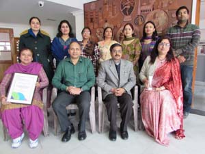 Students along with School authorities displaying British Council International School Award certificate while posing for a photograph.