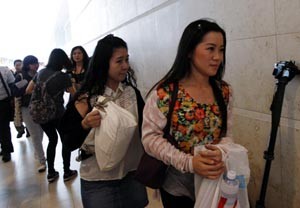 People related to passengers of AirAsia flight QZ 8501arrive at a holding area for next-of-kins and relatives at Changi Airport in Singapore on Sunday.(UNI)