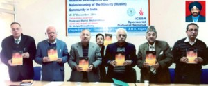 Dr C S Sabharwal’s (Photo in Inset) Urdu novel ‘Khoj’ being released during a seminar at Aligarh Muslim University.