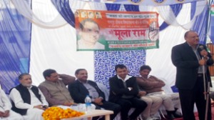 Cong candidate Mula Ram addressing public meeting on Sunday.