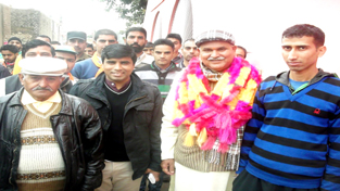 BJP candidate Sham Choudhary posing for photograph alongwith his supporters during public meeting in Suchetgarh constituency.