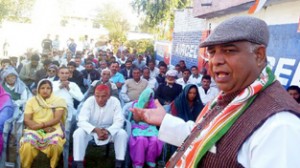 Cong candidate, Ravinder Sharma addresssing public rally in Nowshera on Sunday.
