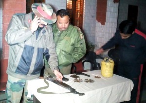 An officer looks at the weapon seized from militant in Poonch on Thursday.—Excelsior/Harbhajan