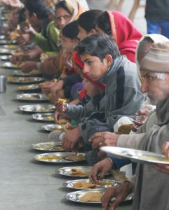 People displaced from the border villages after Pakistani shelling, eating at a relief camp at Samba on Tuesday.
