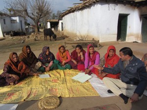 A Self Help Group showing its account book to a banker at village Kawa in district Udhampur. 