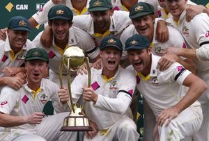 Australia's captain Steven Smith (C) holds the Border-Gavaskar trophy after his team won the four-test series against India 2-0 after the final day of the fourth test at SCS on Saturday. (UNI)