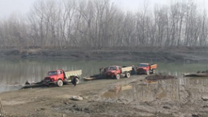Tippers loading sand dug from river bed at Hatiwara in Pulwama district.