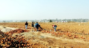 Forest team demolishing structure and retrieving land grabbed at Chowadi in Jammu on Tuesday.
