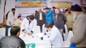 A doctor prescribing medicines to a patient during a medical camp organized by Motor Vehicle Department at Udhampur.