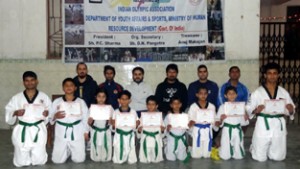 Successful candidates of Colour Belt Promotion Test posing for a group photograph at Jammu.
