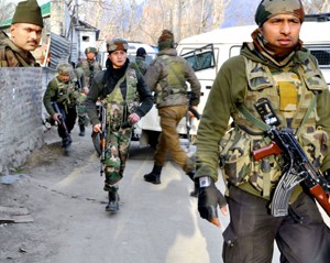 Troops taking position during an encounter in South Kashmir’s Tral area. (Inset) Col M N Rai killed in the gunbattle. -Excelsior/Younis Khaliq