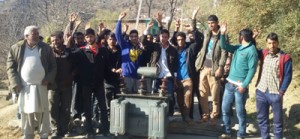 Villagers protesting along with damaged transformer near Thannamandi in Rajouri on Thursday. -Excelsior/ Bhat