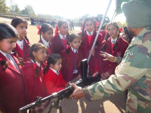 School children having look at weapons displayed by Army during Mela on Army Day at Reasi.