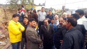 MP Jugal Kishore Sharma interacting with border migrants at a relief camp at Chichi Mata, Samba on Sunday.  —Excelsior/Gautam