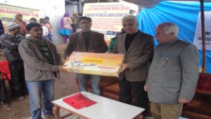 Representatives of AIKS distributing relief among the flood hit people of Saddal.