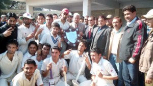 Triumphant GDC Bhaderwah cricket team posing for a group photograph while receiving winners trophy from the chief guest at Jammu University on Thursday.