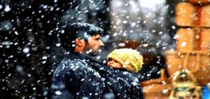 A man carries his daughter as he walks on a snow-covered road closed due to heavy snowfall at Qazigund in Anantnag on Sunday. (PTI)