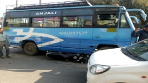 A bike ran over by a mini-bus on Janipur Road at Jammu on Friday. -Excelsior/Rakesh